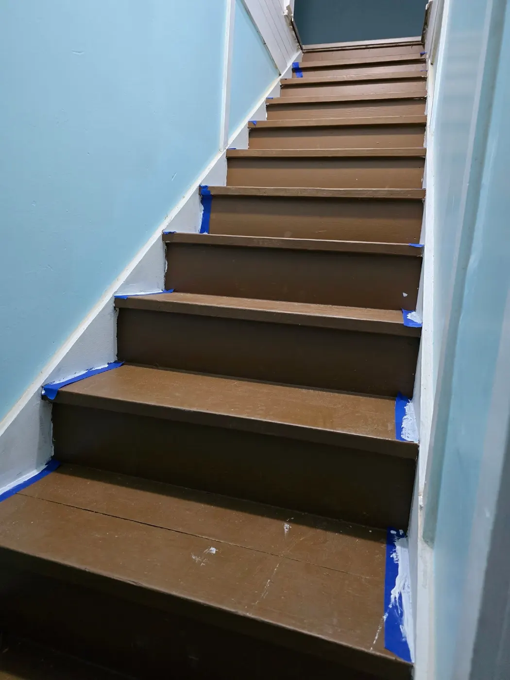 Staircase with fresh dark treads by BuildRight Home Improvement