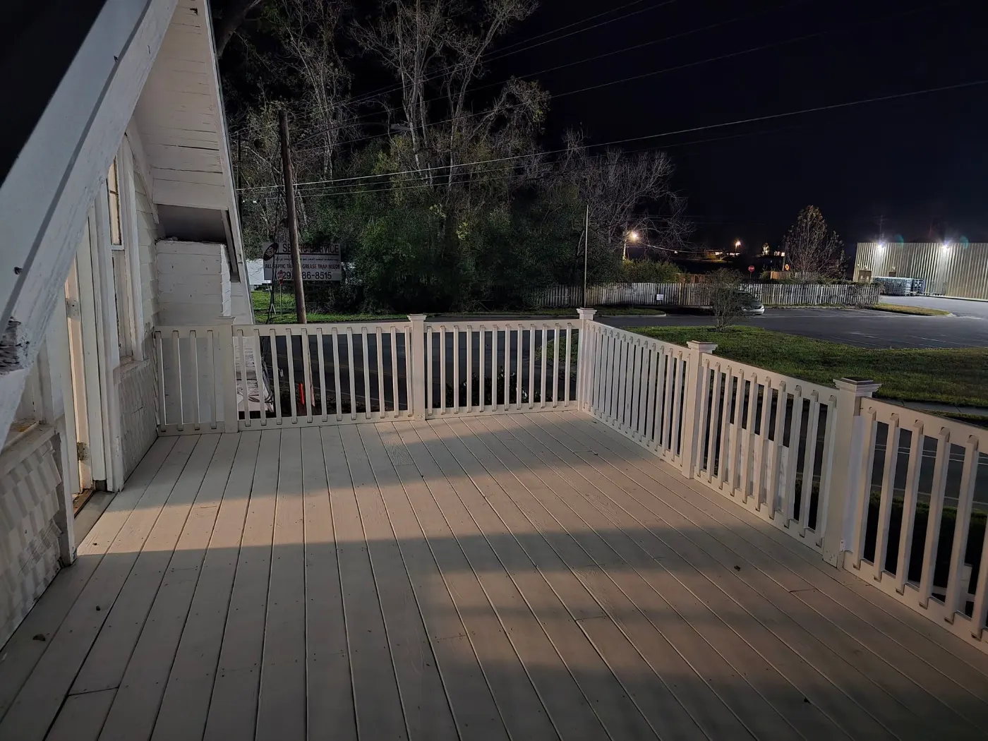 Covered deck with white railings by BuildRight Home Improvement