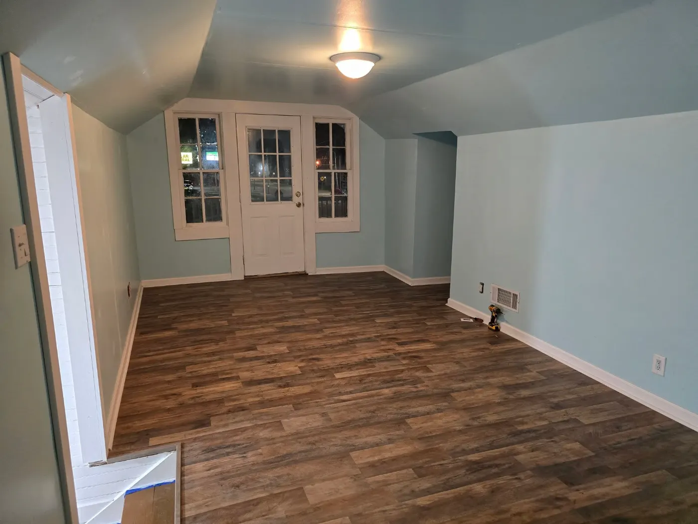 Bright room with new floors and French doors by BuildRight Home Improvement