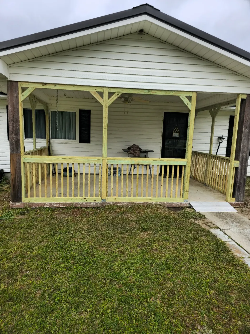 Front porch rebuilt with new railings by BuildRight Home Improvement