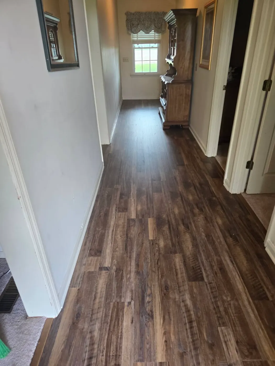 Hallway with new plank flooring by BuildRight Home Improvement