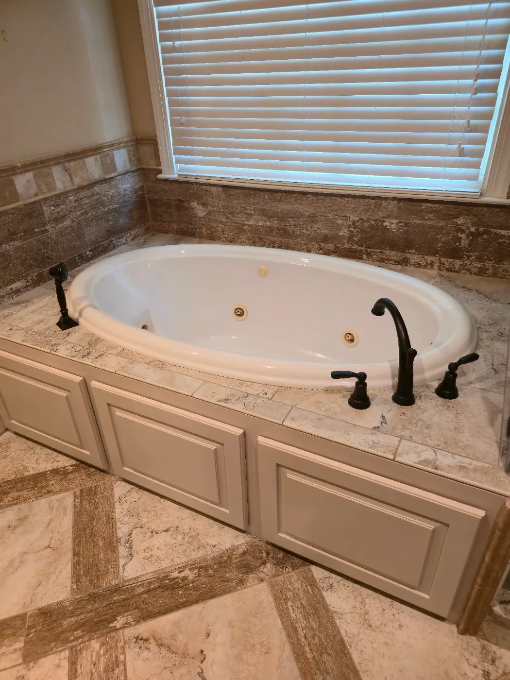 Garden tub with a tile surround by BuildRight Home Improvement