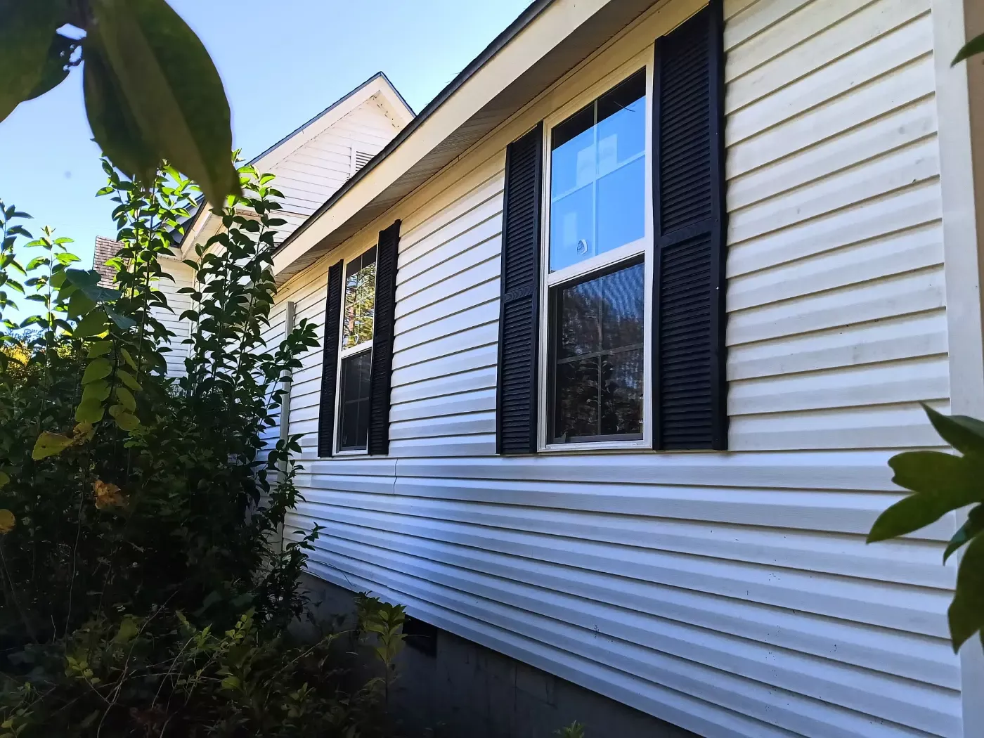 Fresh siding and black shutters by BuildRight Home Improvement