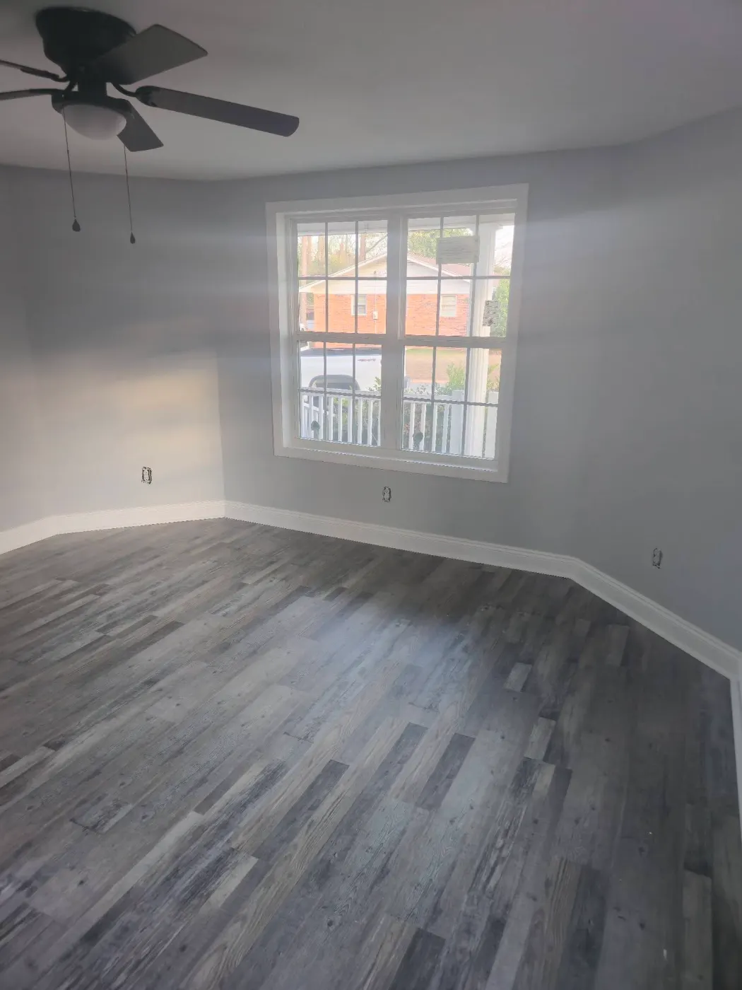 Bright bedroom with new flooring by BuildRight Home Improvement