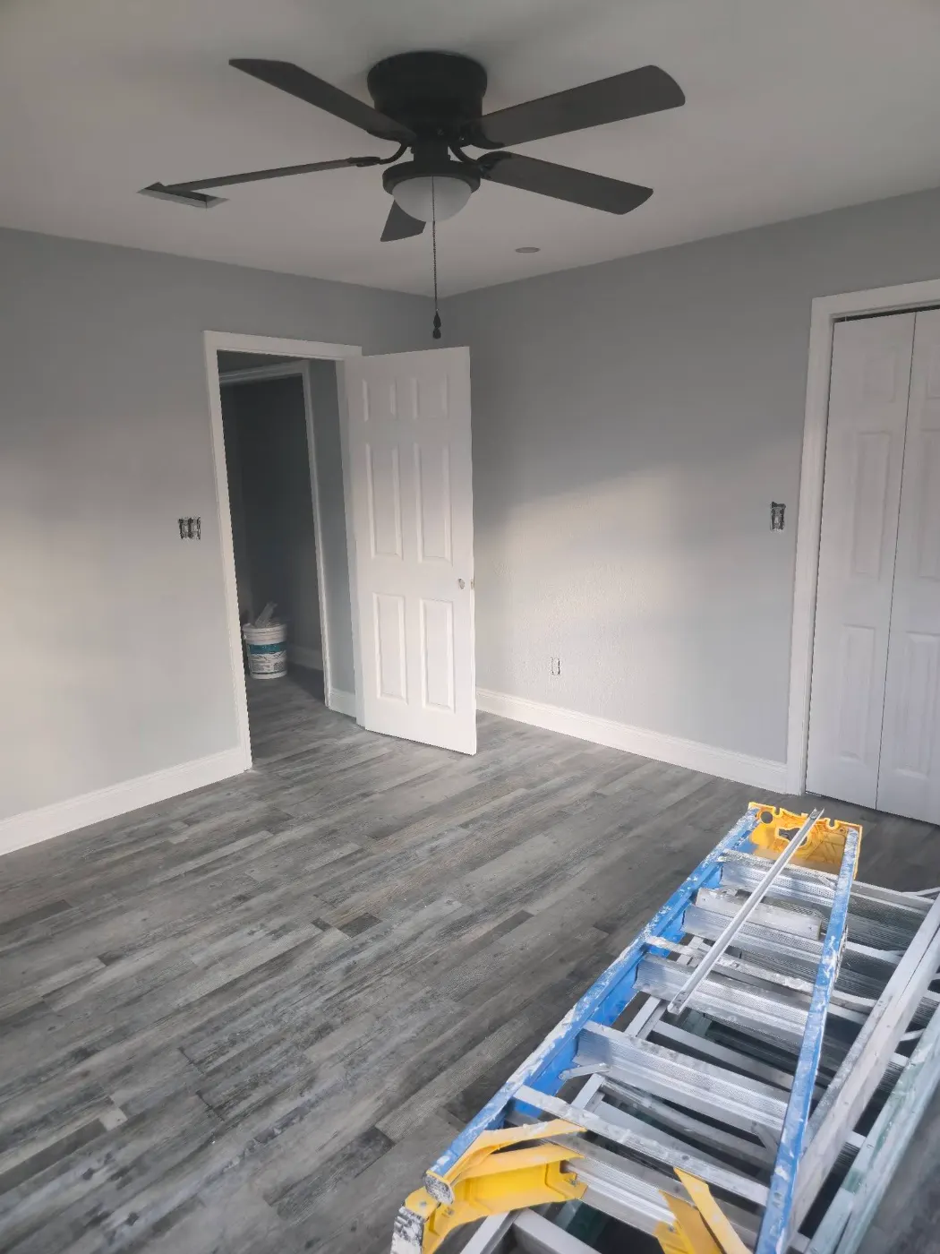 Finished room with a ceiling fan by BuildRight Home Improvement