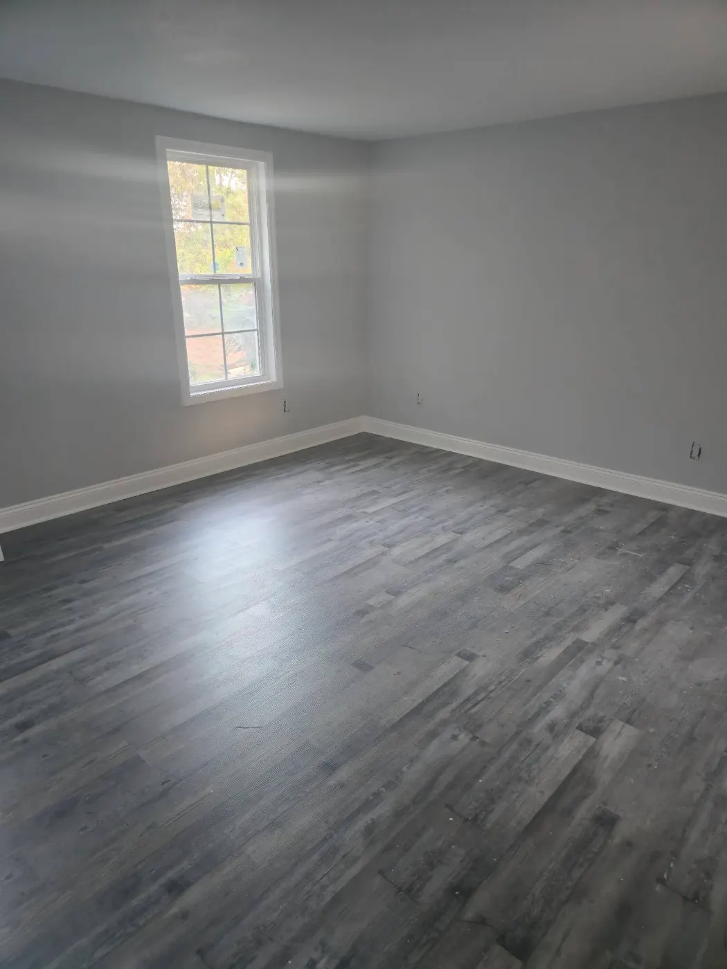 Bedroom finished with plank floors by BuildRight Home Improvement