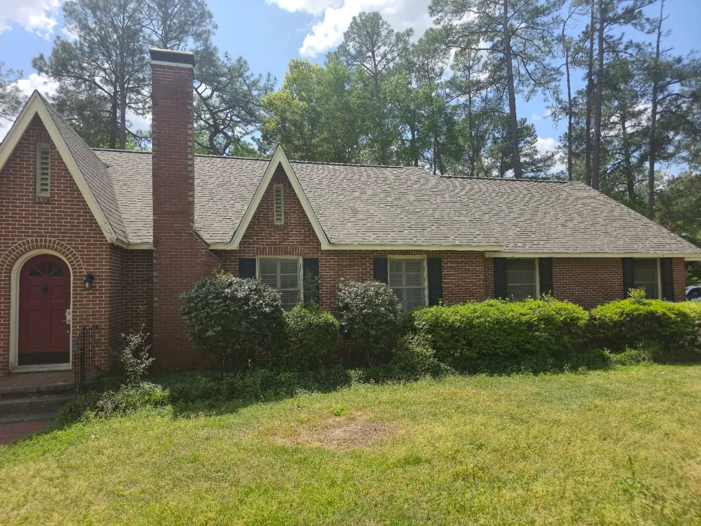 Brick home with a new roof by BuildRight Home Improvement